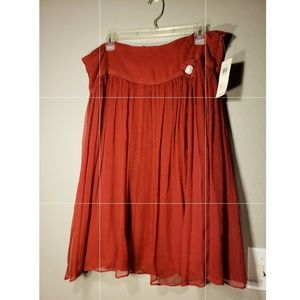 Red skirt with flower detail.